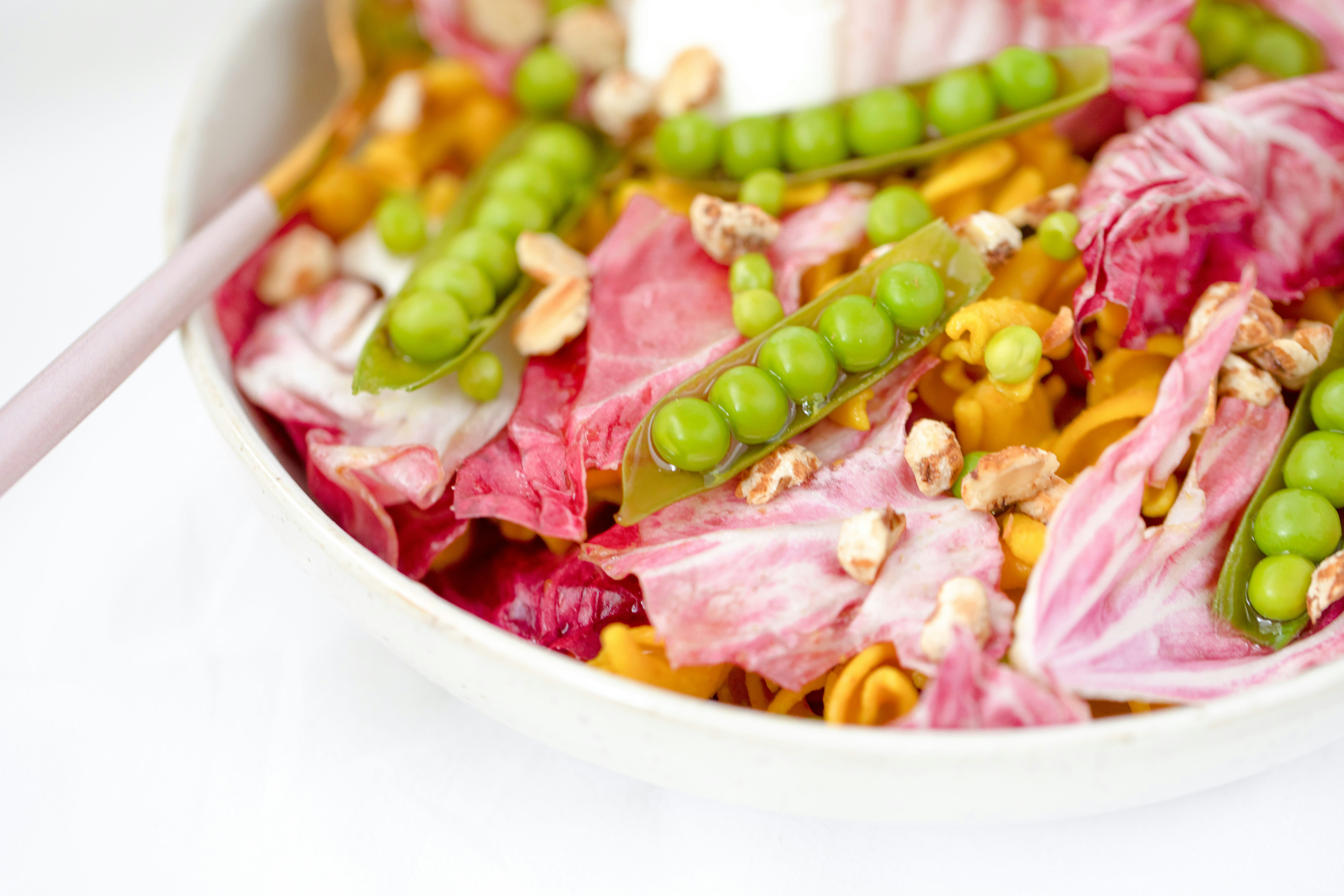 sliced meat with green beans on white ceramic bowl